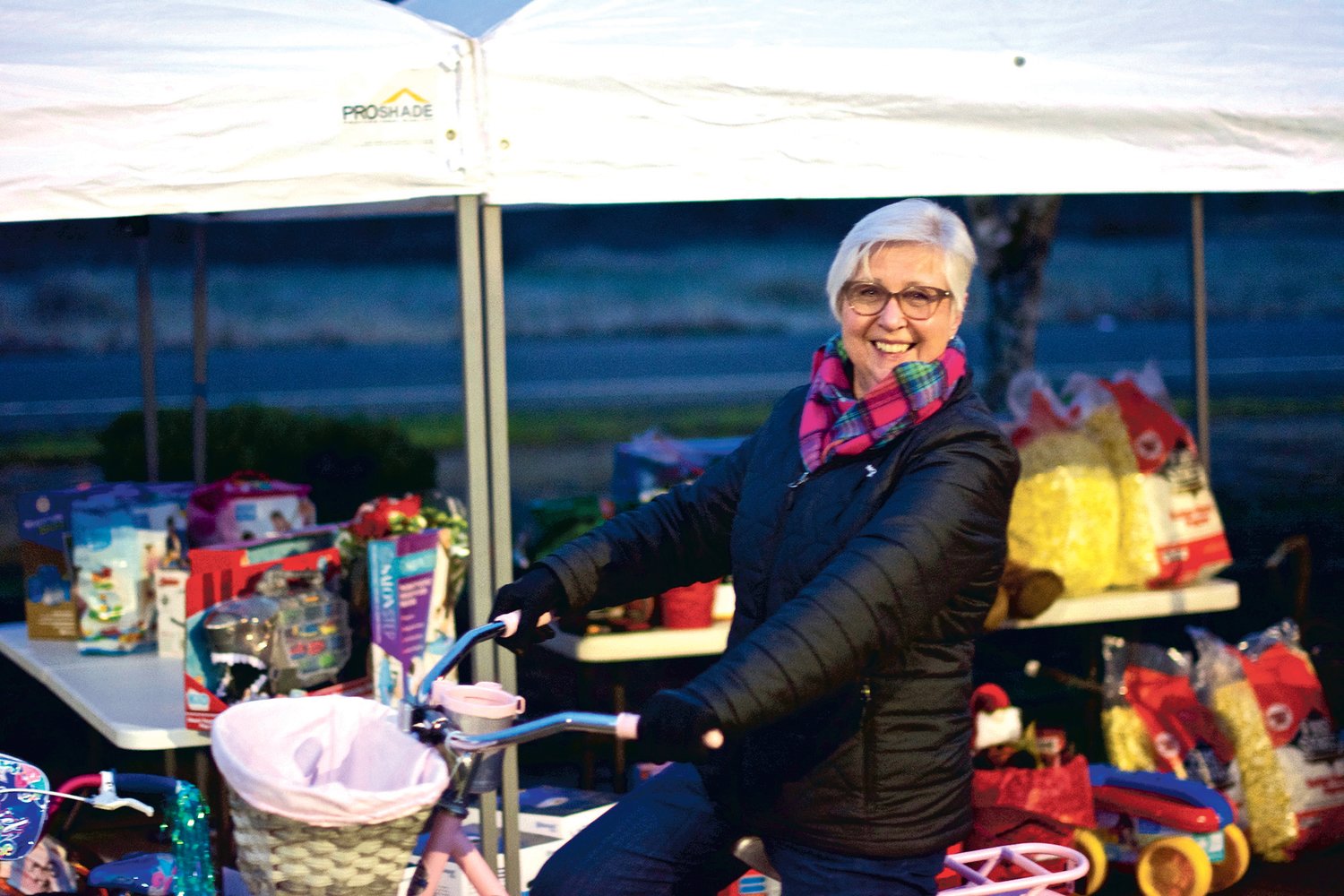 Julie Shaffley, of the Centralia-Chehalis Chamber of Commerce shows off a bike that was given away as a prize for the chamber’s “Choose Local Black Friday” event Lewis County Mall Wednesday night.